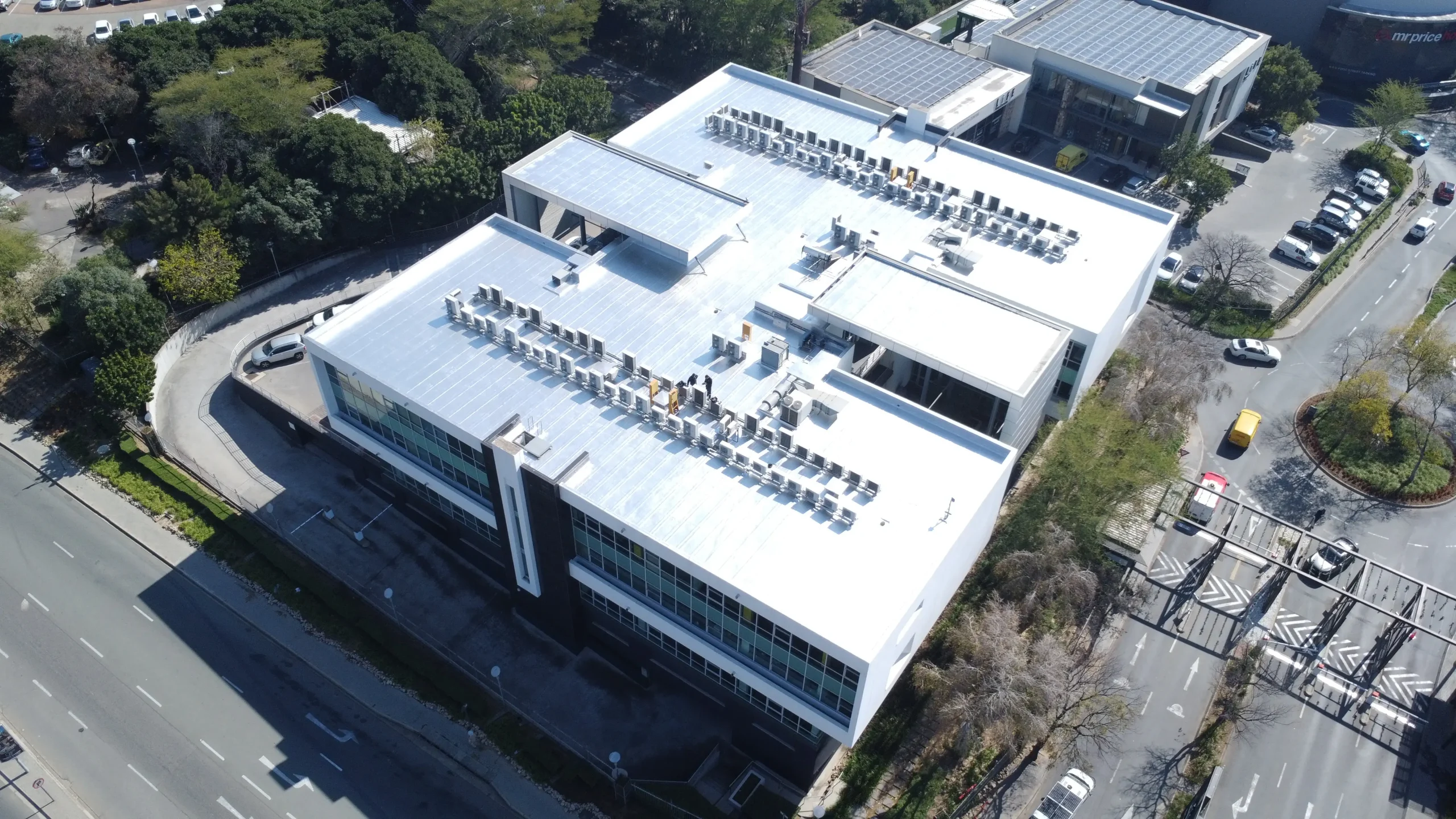 Sicon Group technician applying liquid waterproofing membrane to a commercial flat roof in Gauteng using professional equipment